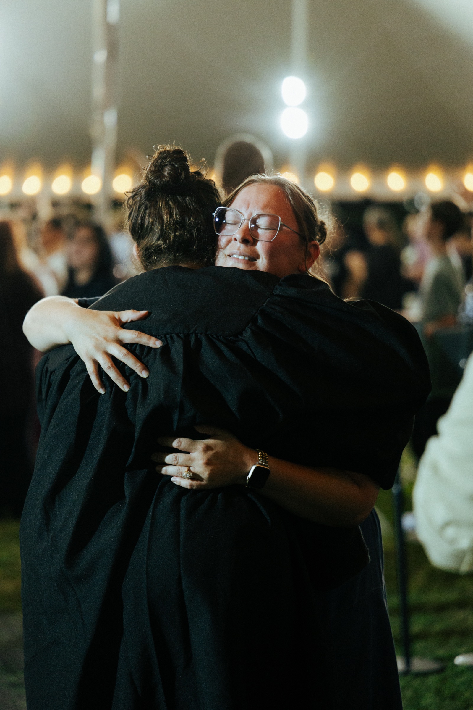 An embrace under the tent lights